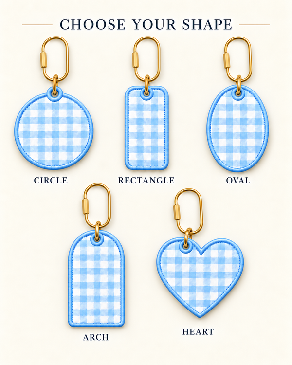 A product selection graphic showing five fabric keychain tag shapes with blue-and-white gingham pattern and gold keyrings: circle, rectangle, oval, arch, and heart. The top text reads 'CHOOSE YOUR SHAPE' and each shape has a label underneath on a light cream background. Five bag charm shapes: circle, rectangle, oval, arch and heart