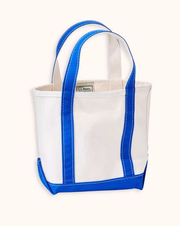 A white canvas tote bag with bright blue trim and handles, featuring a visible 'L.L.
