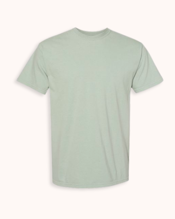 A light sage green crewneck short-sleeve t-shirt displayed flat against a warm off-white background.